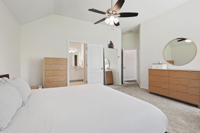 bedroom featuring light carpet, lofted ceiling, ensuite bathroom, and ceiling fan