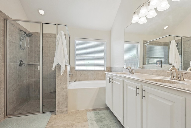 bathroom with tile patterned flooring, vanity, and separate shower and tub