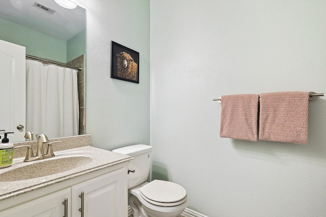 bathroom with vanity, toilet, and walk in shower