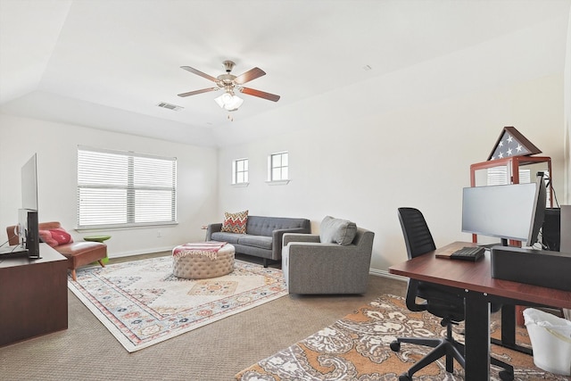 carpeted office with lofted ceiling and ceiling fan