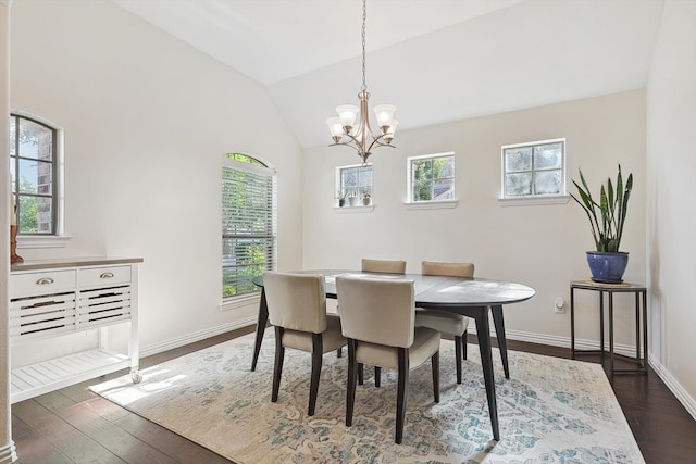 dining room with lofted ceiling, a healthy amount of sunlight, and dark hardwood / wood-style flooring