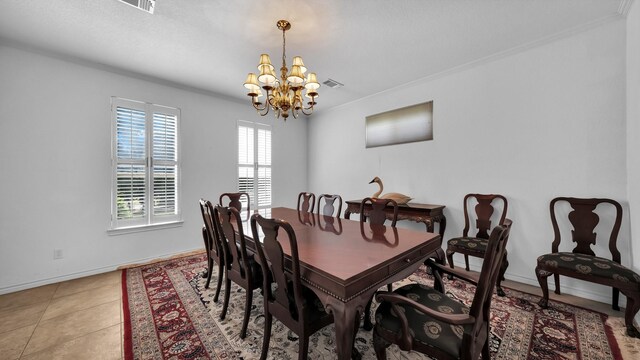 tiled dining space featuring a chandelier and ornamental molding