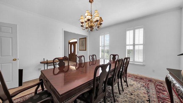 dining area featuring crown molding and a notable chandelier