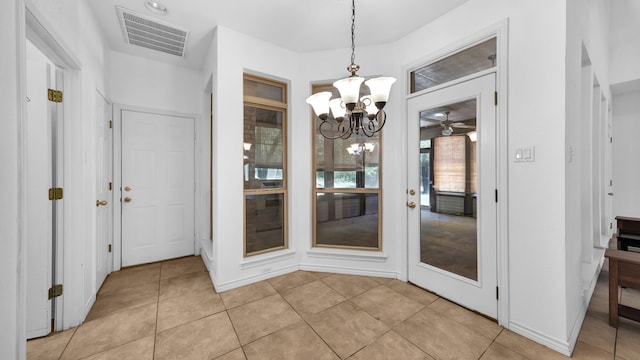 unfurnished dining area with a notable chandelier and light tile patterned flooring