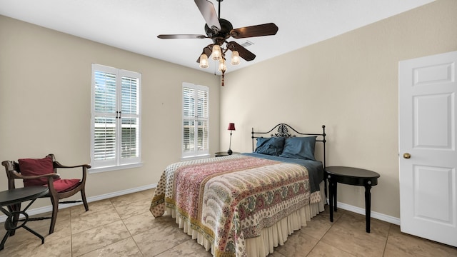 tiled bedroom featuring ceiling fan