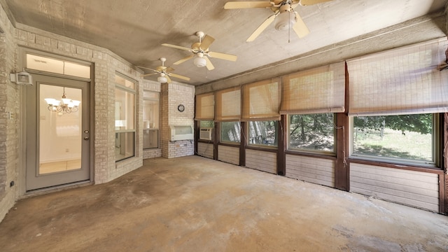 interior space with ceiling fan with notable chandelier