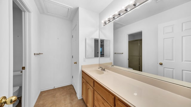 bathroom with tile patterned flooring, vanity, and toilet