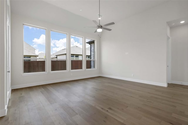 unfurnished room with vaulted ceiling, hardwood / wood-style floors, and ceiling fan