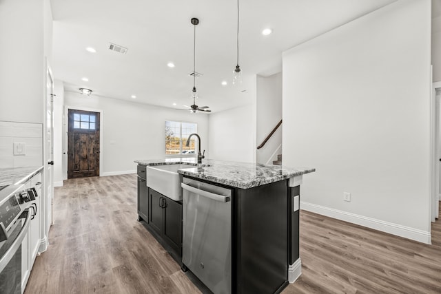 kitchen featuring stainless steel appliances, hanging light fixtures, white cabinetry, and light wood-type flooring