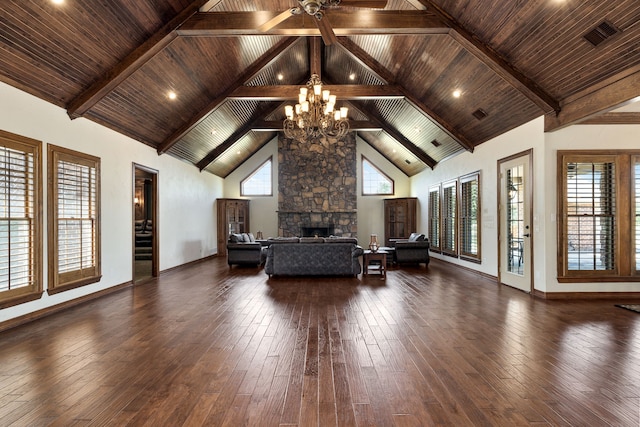 interior space featuring a fireplace, high vaulted ceiling, dark hardwood / wood-style floors, and a notable chandelier