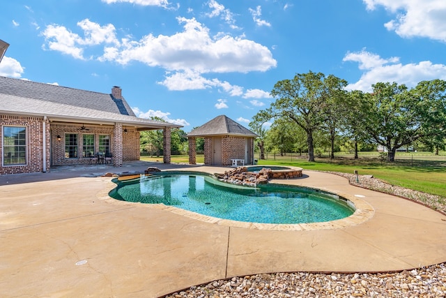 view of swimming pool with a gazebo, ceiling fan, a patio area, and exterior fireplace