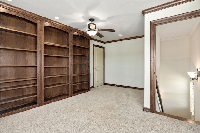 unfurnished bedroom with ceiling fan, crown molding, and light carpet