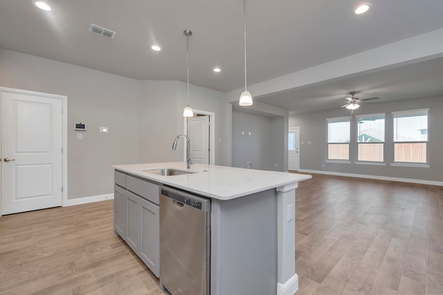 kitchen with decorative light fixtures, light hardwood / wood-style floors, stainless steel dishwasher, an island with sink, and ceiling fan