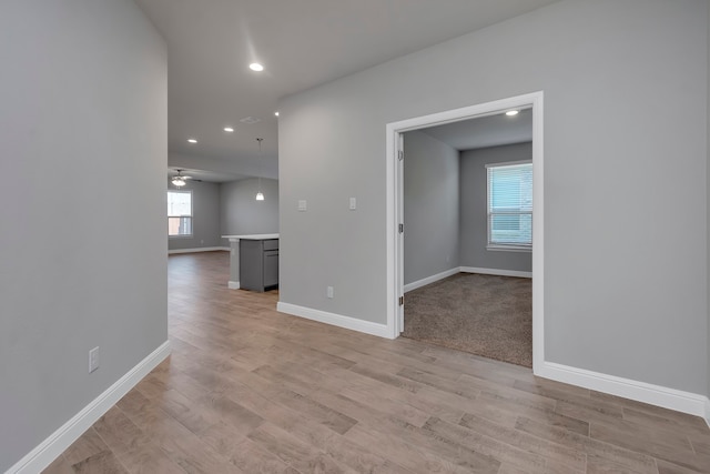 carpeted spare room with a wealth of natural light and ceiling fan