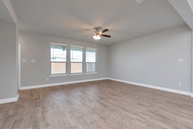 spare room featuring light hardwood / wood-style flooring and ceiling fan