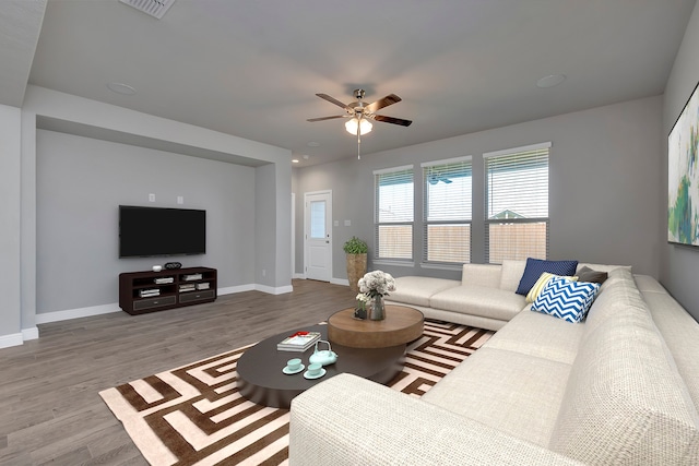 living room featuring hardwood / wood-style flooring and ceiling fan