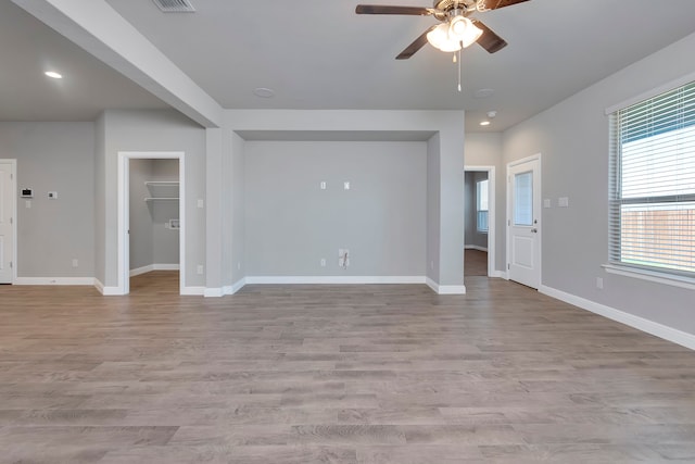 empty room with wood-type flooring and ceiling fan