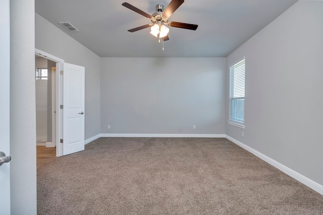 carpeted spare room featuring ceiling fan