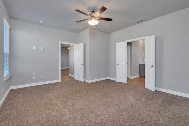 unfurnished bedroom featuring carpet flooring and ceiling fan