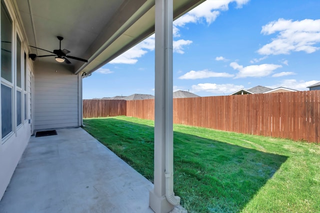 view of yard with a patio area and ceiling fan