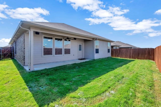 rear view of property featuring a patio, a yard, and ceiling fan