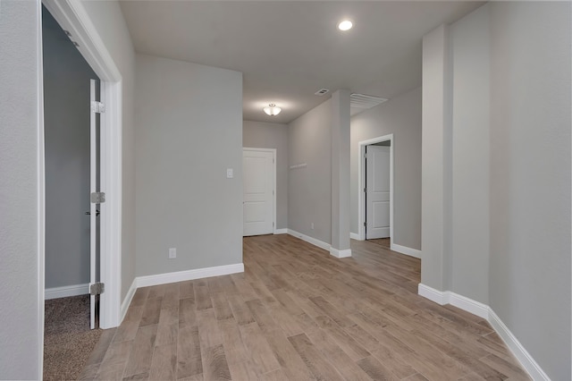 unfurnished room with light wood-type flooring