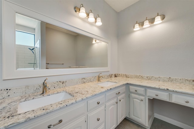 bathroom featuring tile patterned floors, vanity, and a shower