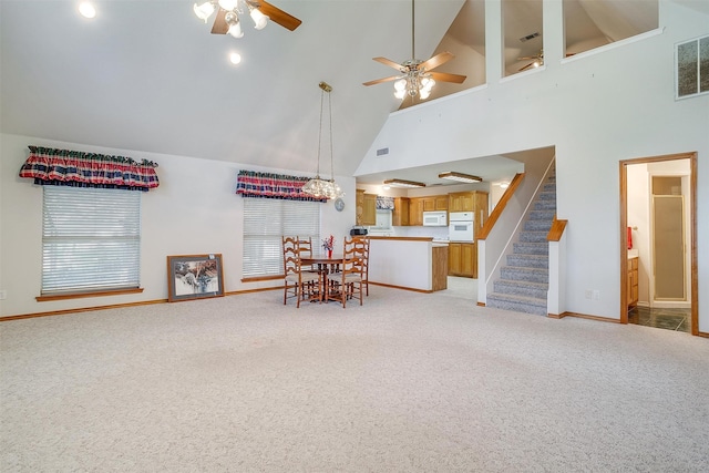 living room featuring ceiling fan, light colored carpet, and high vaulted ceiling