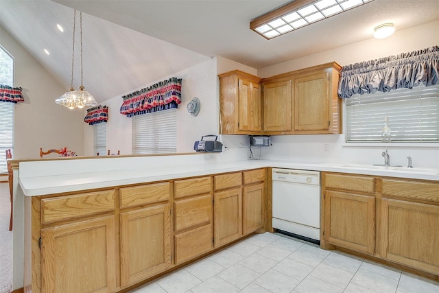 kitchen featuring lofted ceiling, sink, dishwasher, decorative light fixtures, and kitchen peninsula