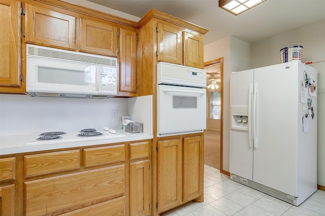 kitchen featuring light tile patterned floors and white appliances