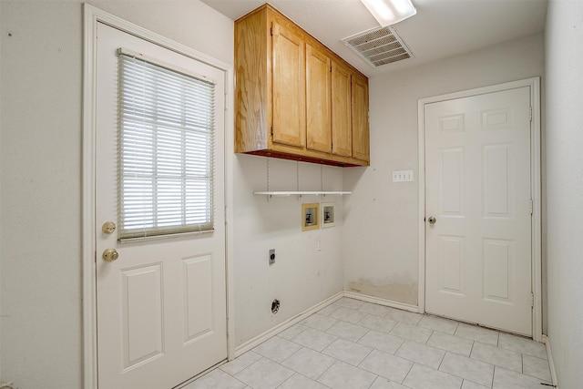 laundry area with cabinets, washer hookup, hookup for an electric dryer, and light tile patterned floors