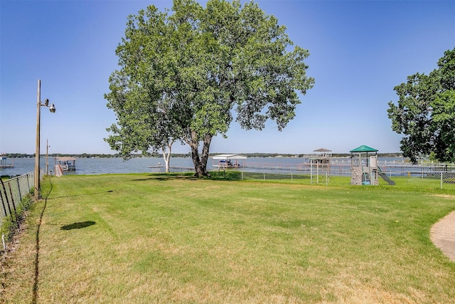 view of yard featuring a playground and a water view