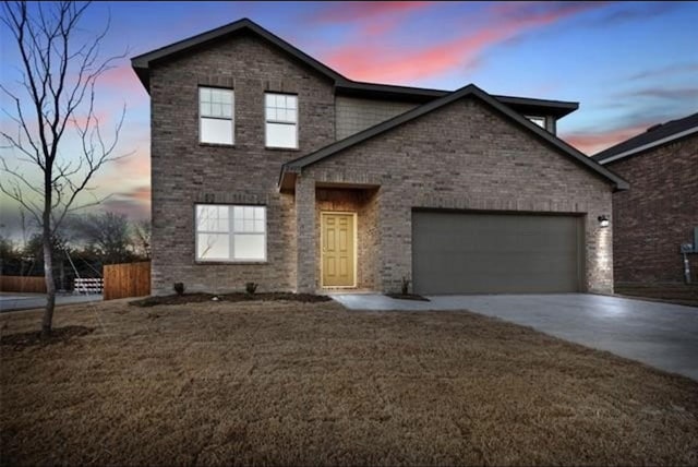 view of front of property featuring a yard and a garage