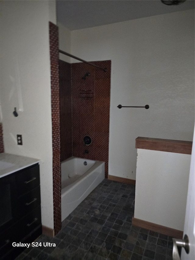 bathroom featuring shower / bathtub combination, vanity, and tile patterned floors