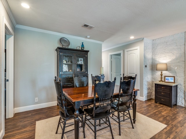 dining room featuring a textured ceiling, crown molding, and dark wood-type flooring