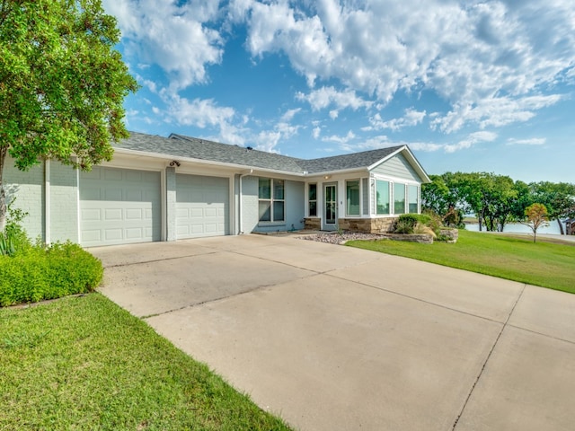 single story home featuring a garage and a front yard