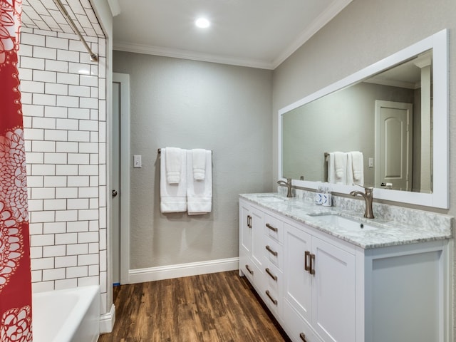 bathroom featuring crown molding, shower / bath combo with shower curtain, wood-type flooring, and double sink vanity