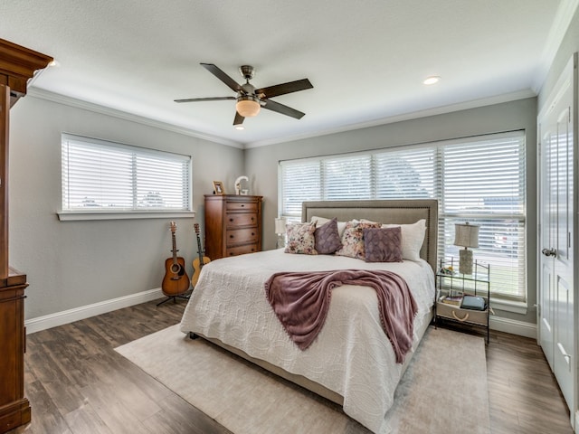 bedroom with ceiling fan, crown molding, and dark hardwood / wood-style flooring