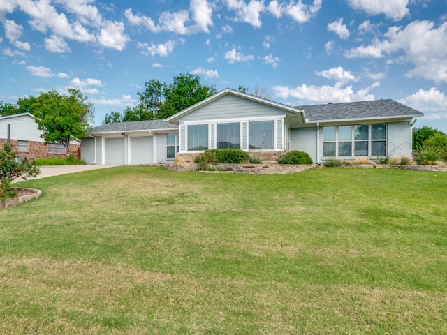 ranch-style house with a garage and a front yard