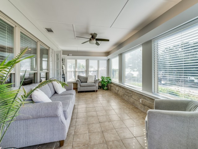 sunroom / solarium featuring plenty of natural light and ceiling fan