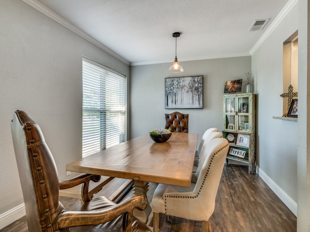 dining space with a textured ceiling, crown molding, and dark hardwood / wood-style floors