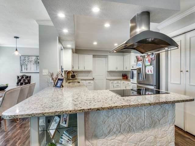 kitchen with dark hardwood / wood-style flooring, stainless steel refrigerator with ice dispenser, white cabinets, island range hood, and kitchen peninsula