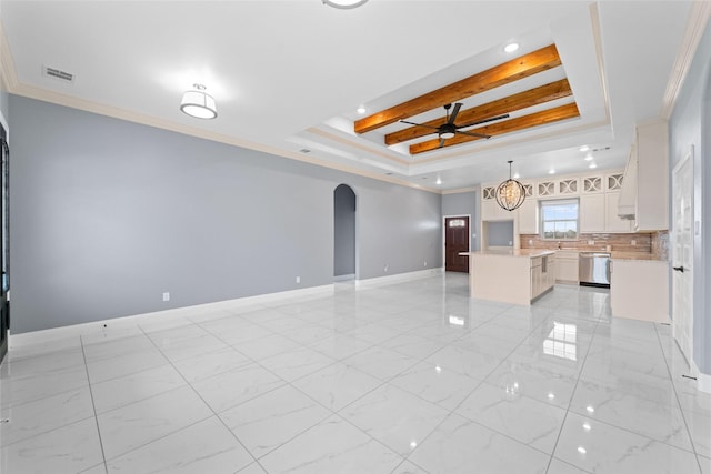 kitchen featuring a center island, stainless steel dishwasher, decorative light fixtures, a tray ceiling, and white cabinets