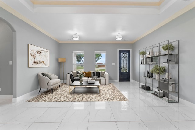 living room featuring a tray ceiling and ornamental molding