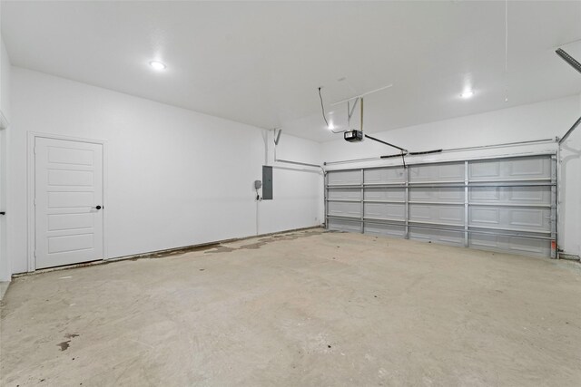 garage with electric panel and a garage door opener