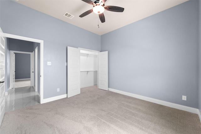 unfurnished bedroom featuring ceiling fan, light carpet, and a closet