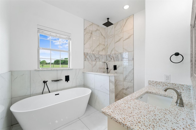 bathroom with vanity, shower with separate bathtub, and tile walls