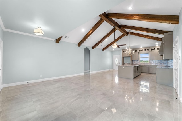 unfurnished living room featuring beamed ceiling, ceiling fan, sink, and high vaulted ceiling