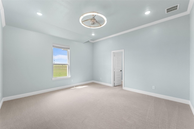 spare room with light colored carpet and ornamental molding