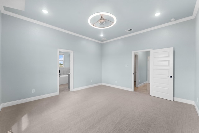 spare room with light carpet and crown molding